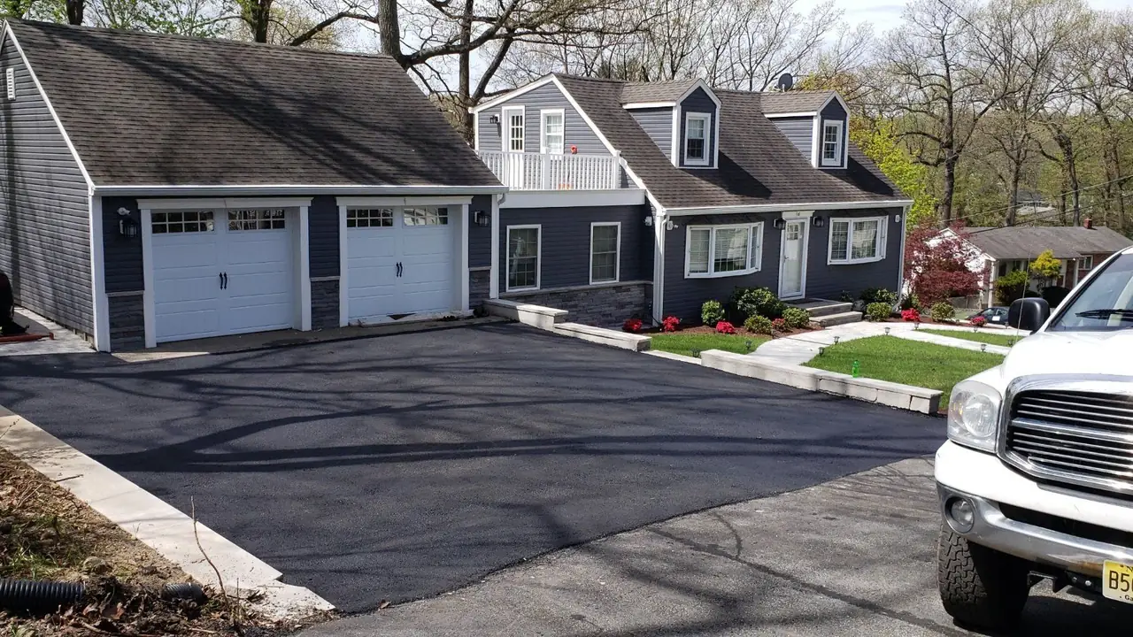 Completed asphalt driveway at a three-bay garage home in New Jersey