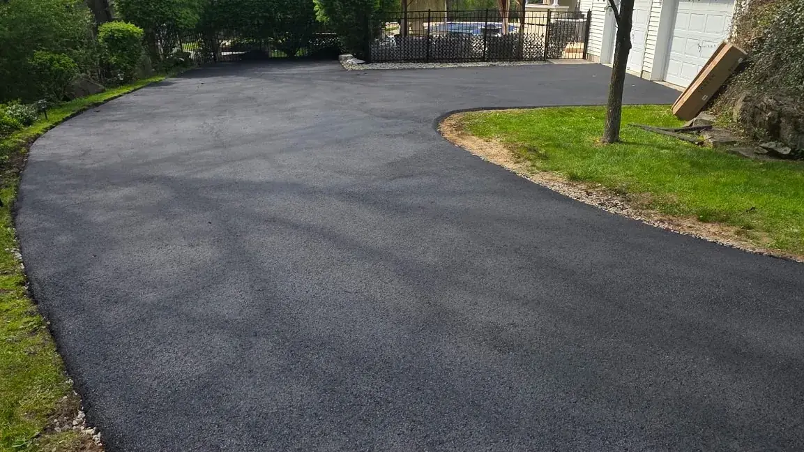 Curved asphalt driveway sweeping up to a New Jersey home