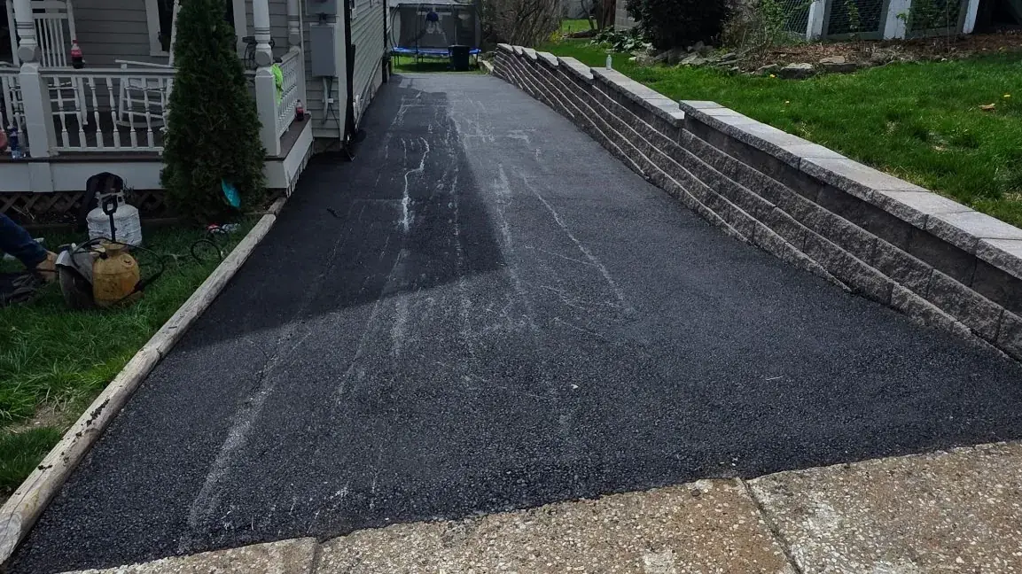 Paver walkway and retaining wall hardscaping beside a New Jersey driveway